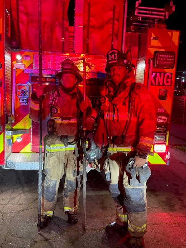 Firefighters pose after a fire